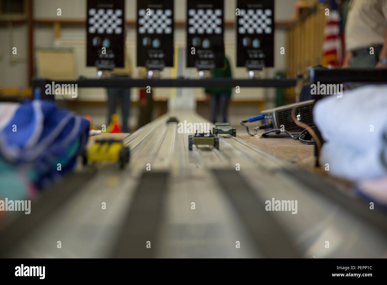 Wooden racecars made by Cub Scout Pack 78 speed past the finish line