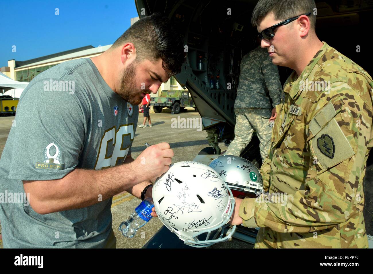 Pittsburgh Steelers Guard David DeCastro signs a football helmet for