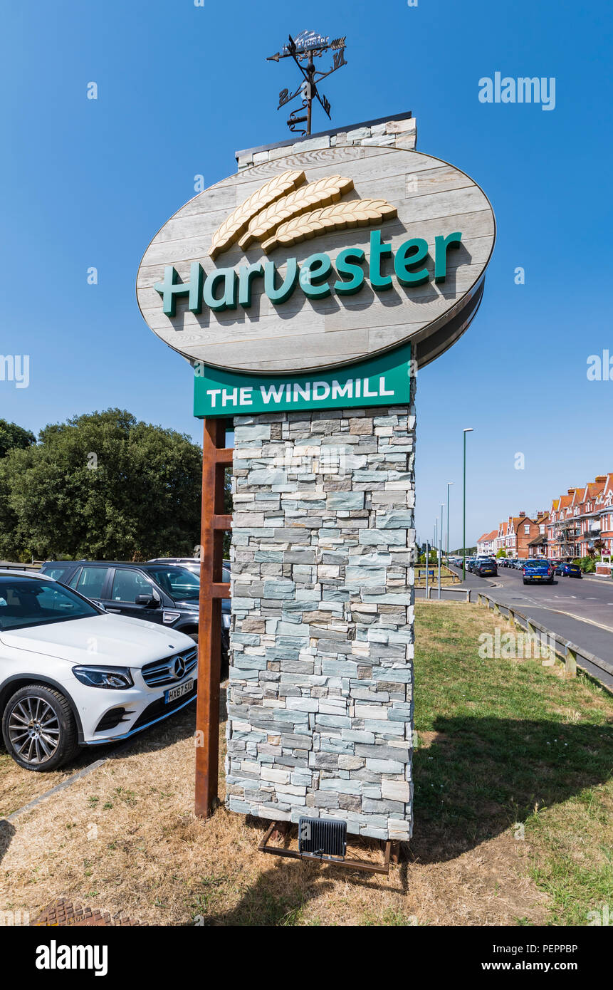Sign outside the Windmill Harvester pub and restaurant in Littlehampton, West Sussex, England, UK. Stock Photo