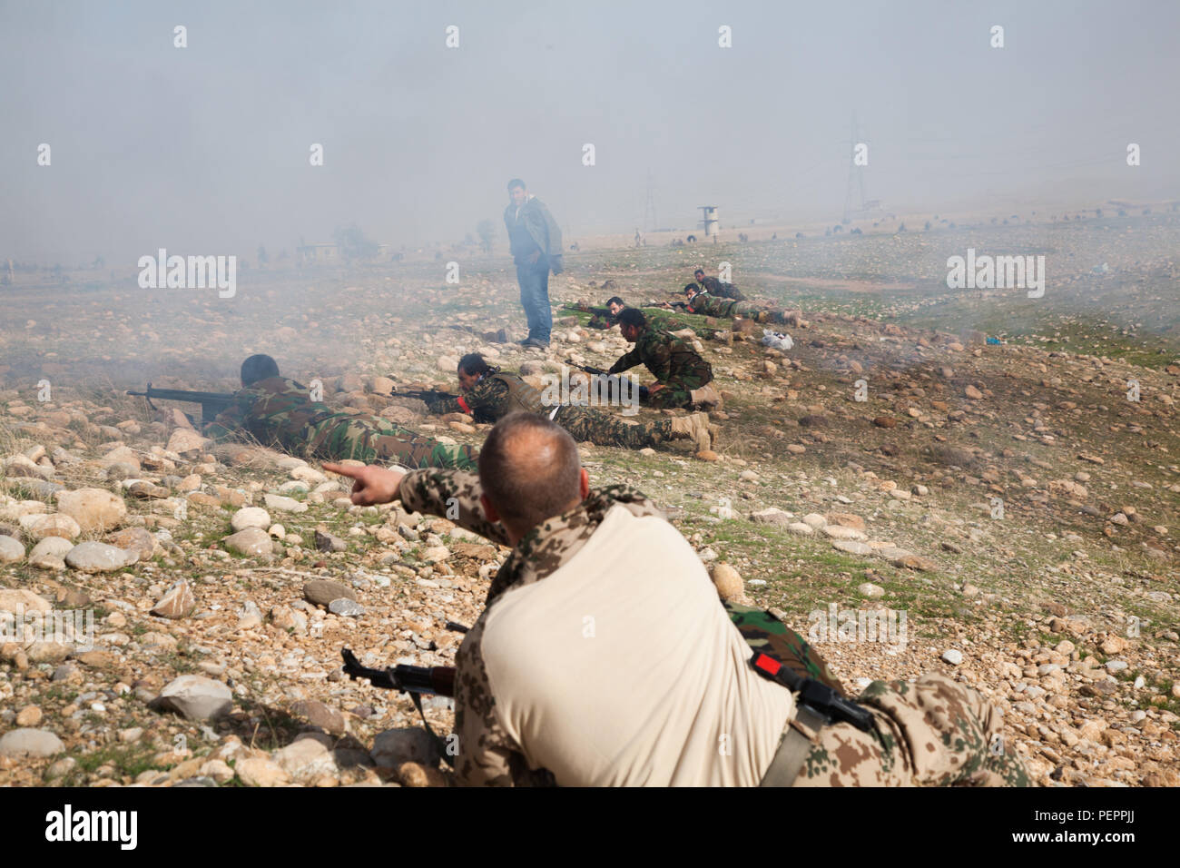 Peshmerga soldiers prepare to move forward during a training exercise ...