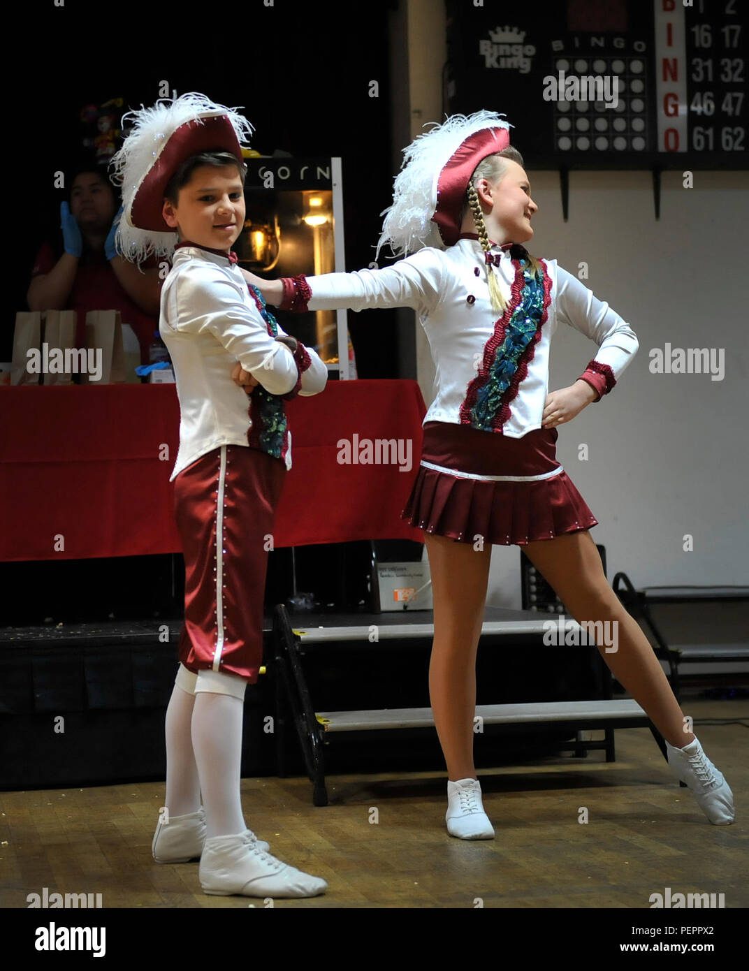 Mareike Schaumloeffel and Maris Schuler, a dance “tanzpaar,” or couple, perform a dance during a Kinder Fasching celebration Jan. 25, 2016, at Ramstein Air Base, Germany. The dance teams performed routines for a crowd to boost morale and excitement for upcoming Fasching parades. (U.S. Air Force photo/Airman 1st Class Larissa Greatwood) Stock Photo