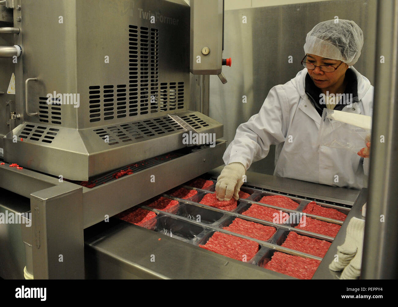 Teresa George, Defense Commissary Agency employee, quality controls ground beef at the Ramstein Central Meat Processing Plant Jan. 25, 2016, at Ramstein Air Base, Germany. The Ramstein CMPP consolidated with the plants in Rhein-Main and Lakenheath on March 16, 1998, and is the only meat processing plant in the Department of Defense. (U.S. Air Force photo/Airman 1st Class Larissa Greatwood) Stock Photo