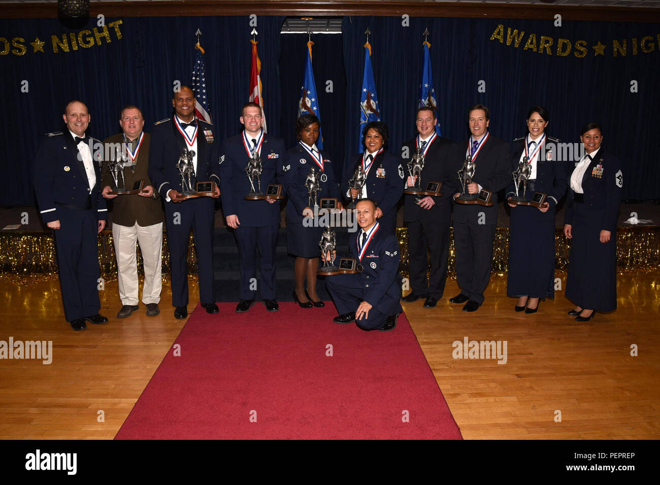 The 21st Space Wing held its annual awards banquet at The Club Jan. 28, 2016. Col. Douglas Schiess, 21 SW/CC and Chief Master Sgt. Idalia Peele hand out awards for civilian, Airman, NCO, Senior NCO, Junior and Field Grade officer. Stock Photo