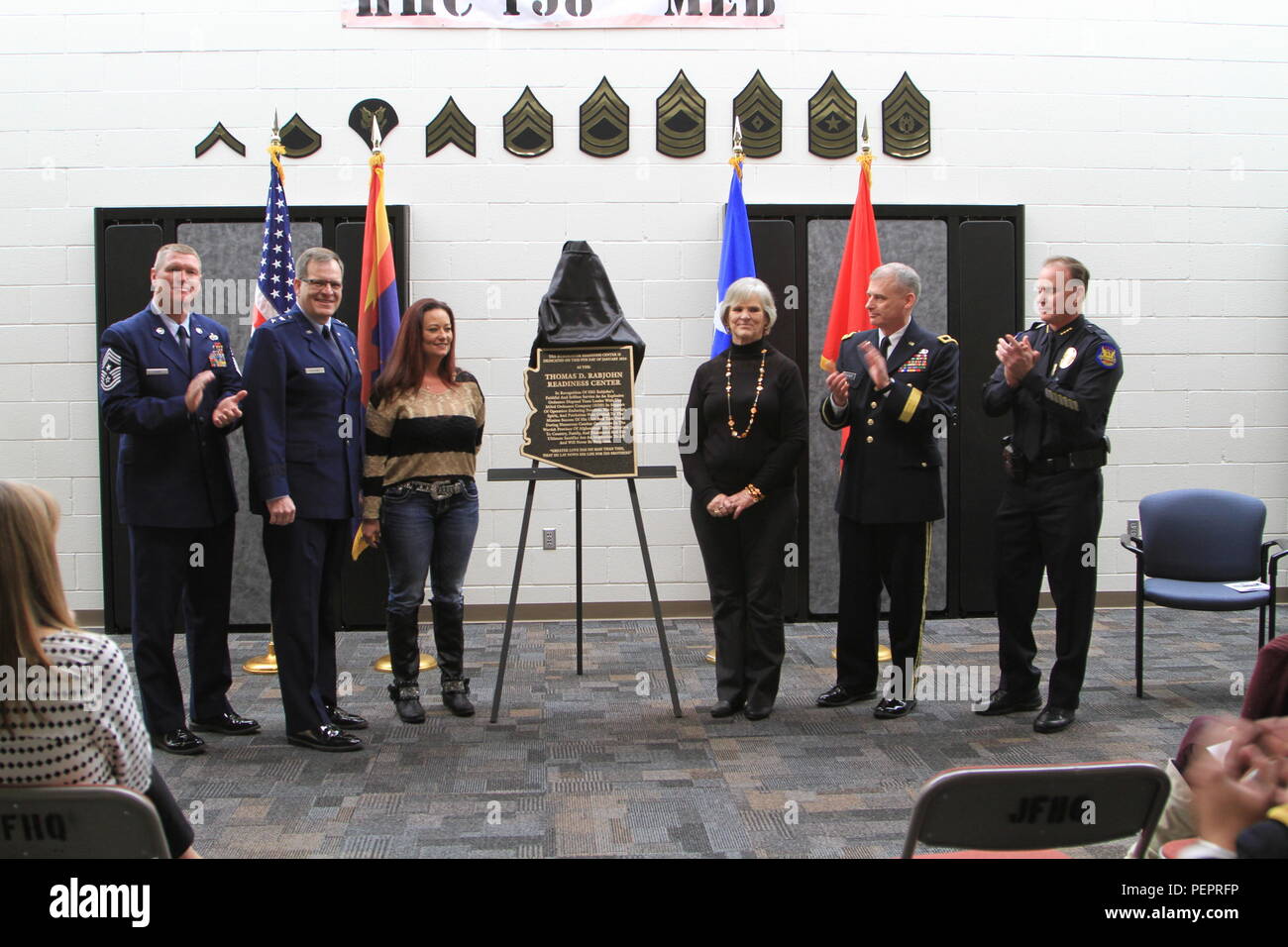 Members of the official party unveil a plaque that will be placed in ...
