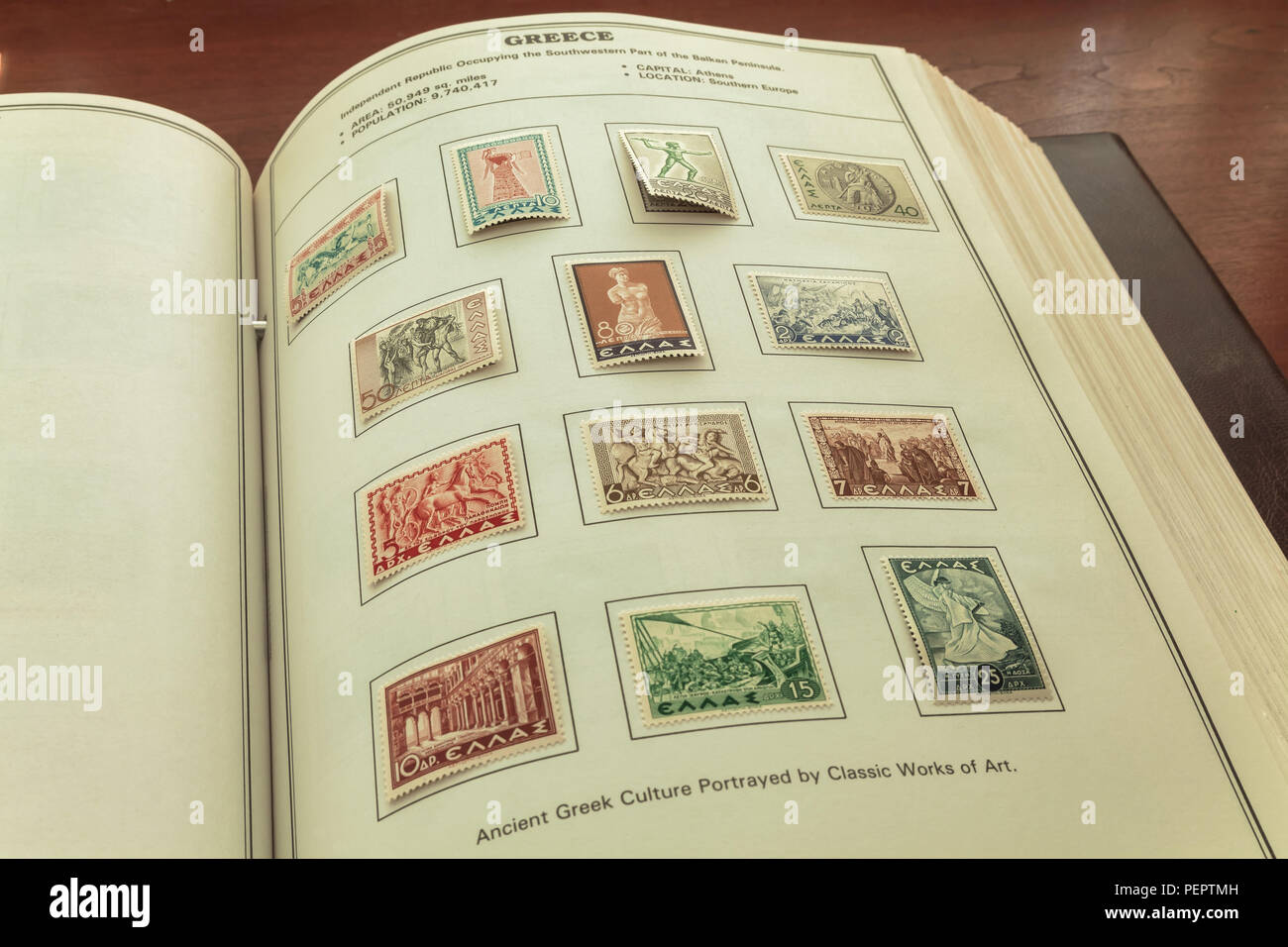 Stamps collection album with one page containing a set of commemorative stamps portraying ancient Greek culture by classic works of art Stock Photo