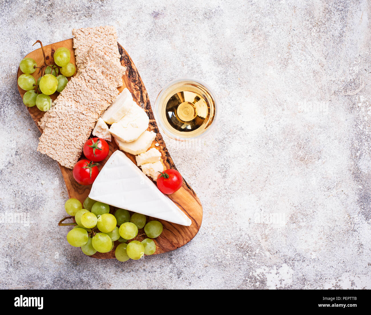 Cheese plate with brie, grape and wine Stock Photo