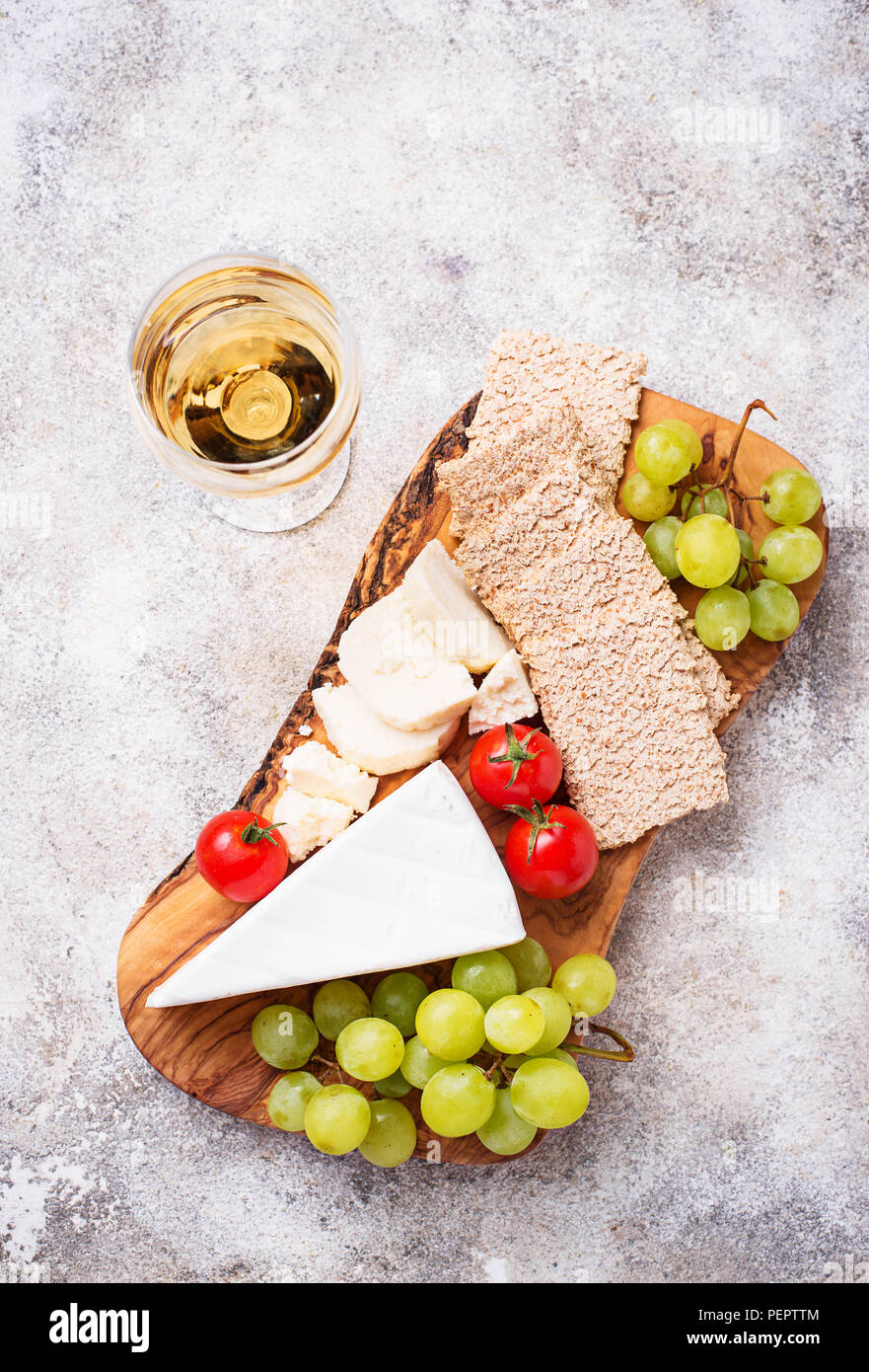 Cheese plate with brie, grape and wine Stock Photo