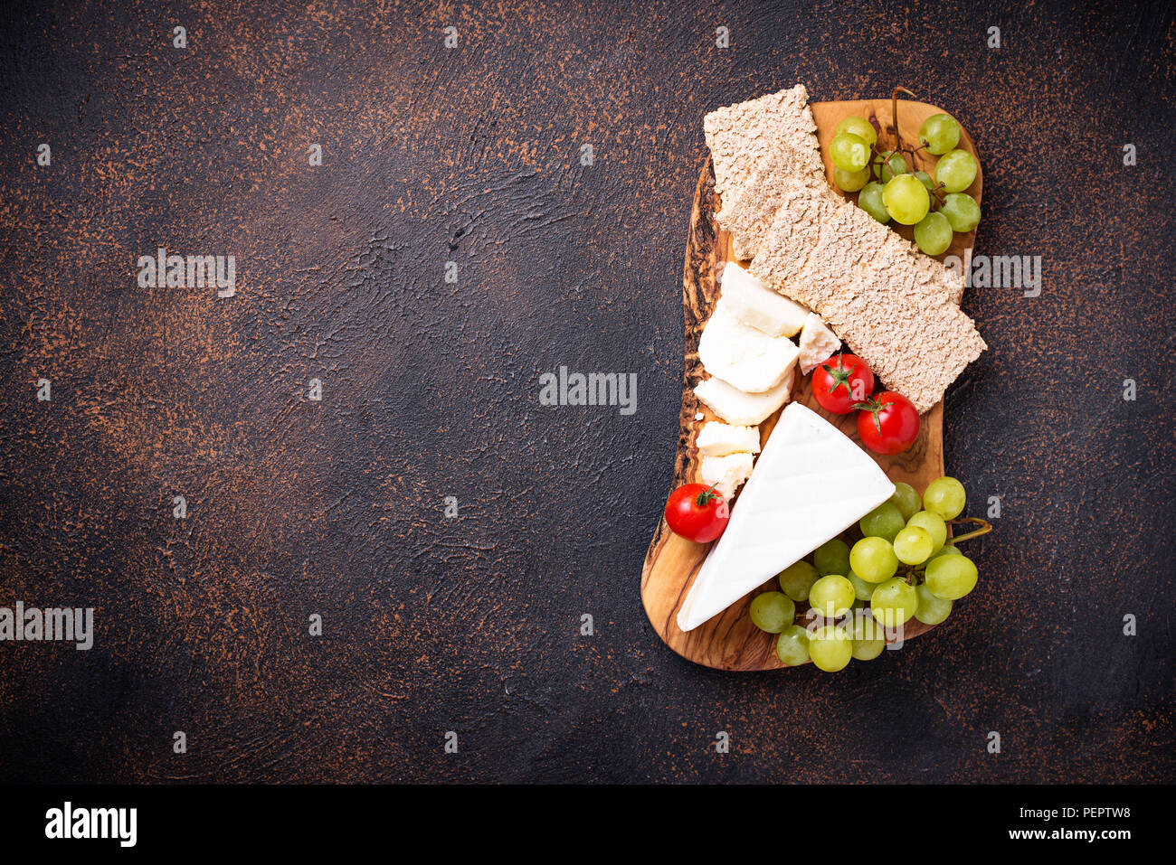 Cheese plate with brie, grape and wine Stock Photo