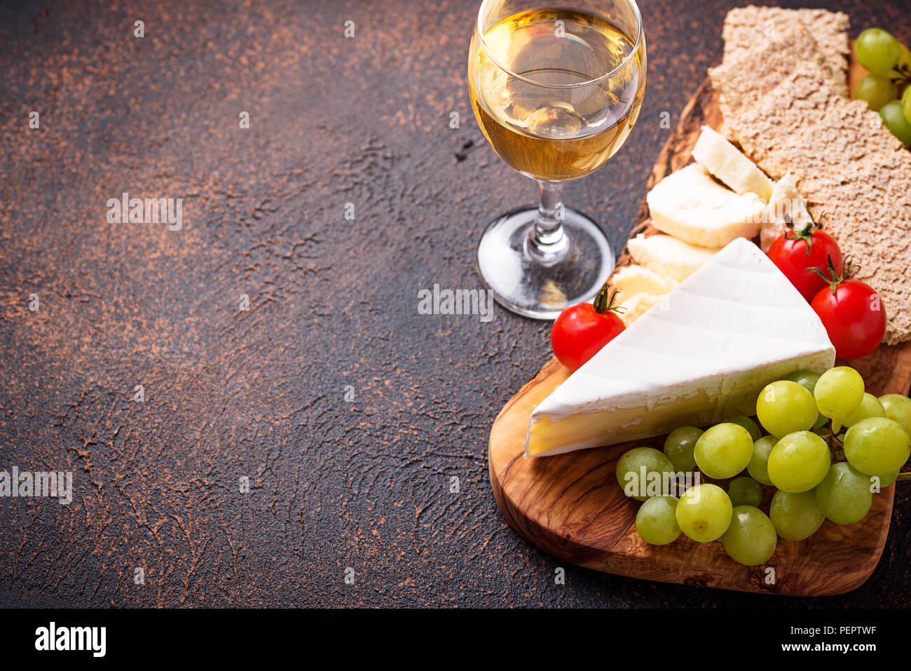 Cheese plate with brie, grape and wine Stock Photo