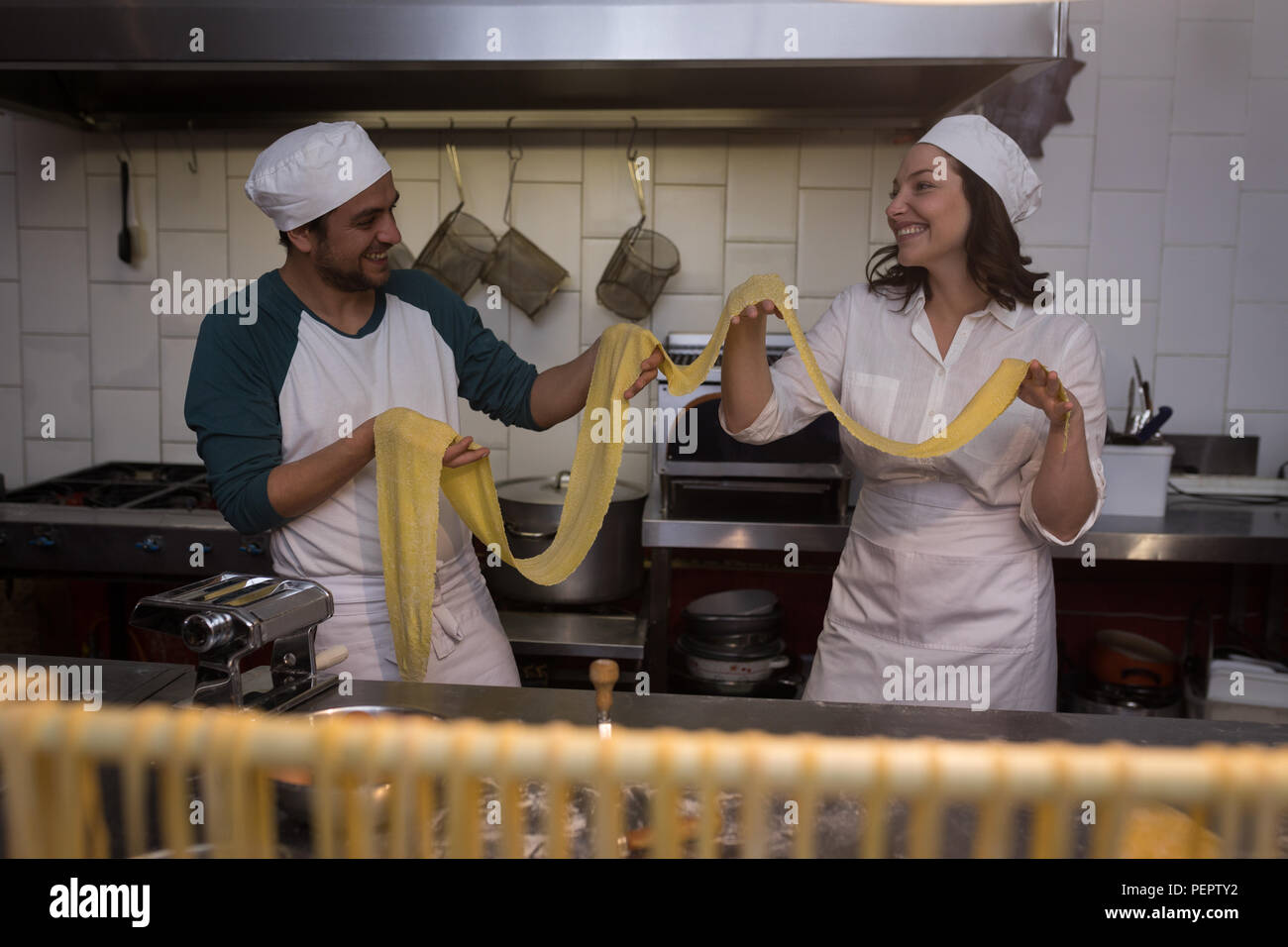 Bakers preparing pasta in bakery Stock Photo
