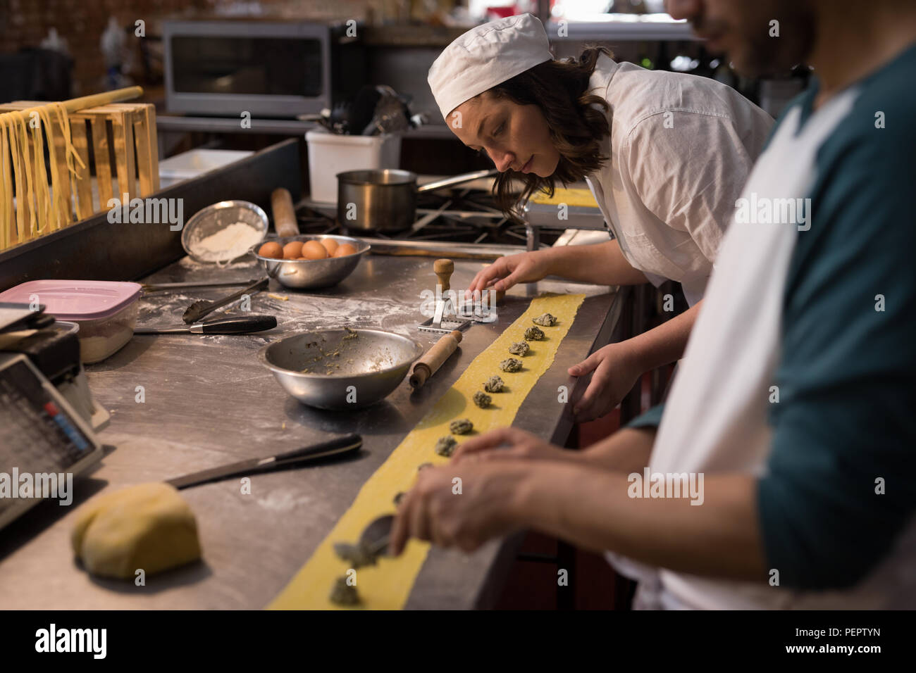 Bakers preparing pasta in bakery Stock Photo