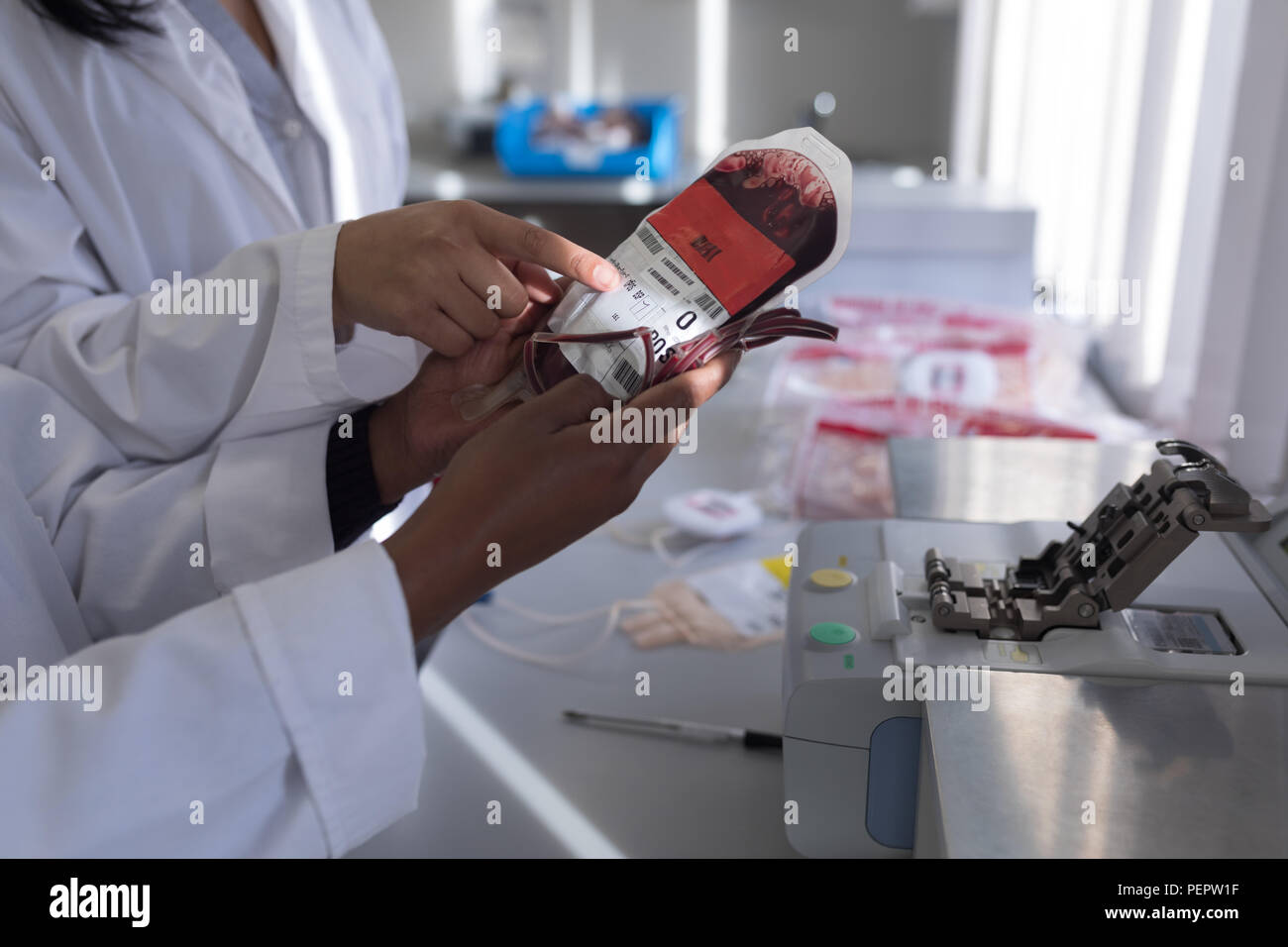 Laboratory technicians discussing over blood bag Stock Photo