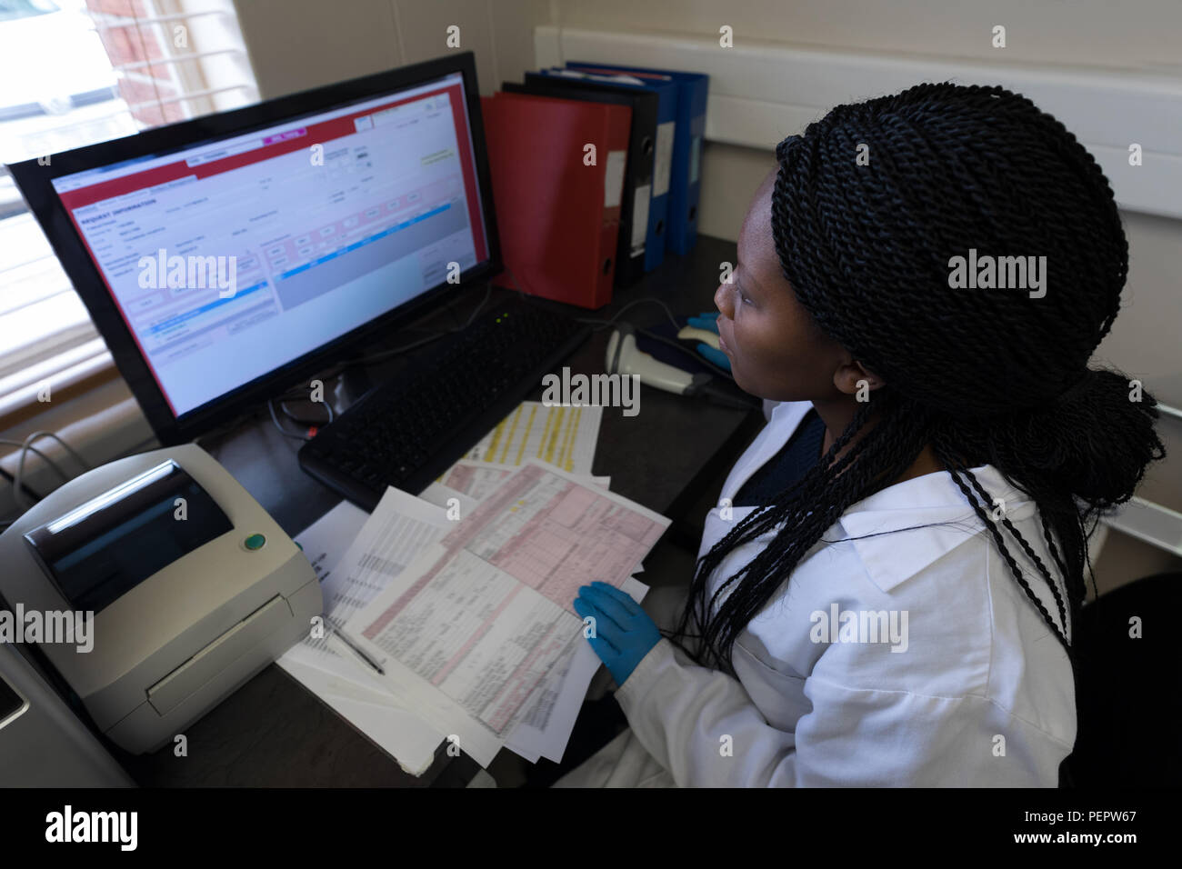 Laboratory technician working on computer Stock Photo Alamy