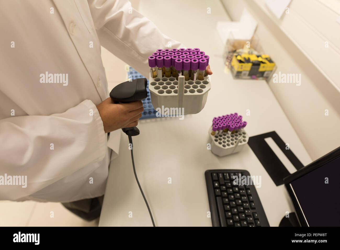 Laboratory technician scanning bar code of test tube rack Stock Photo