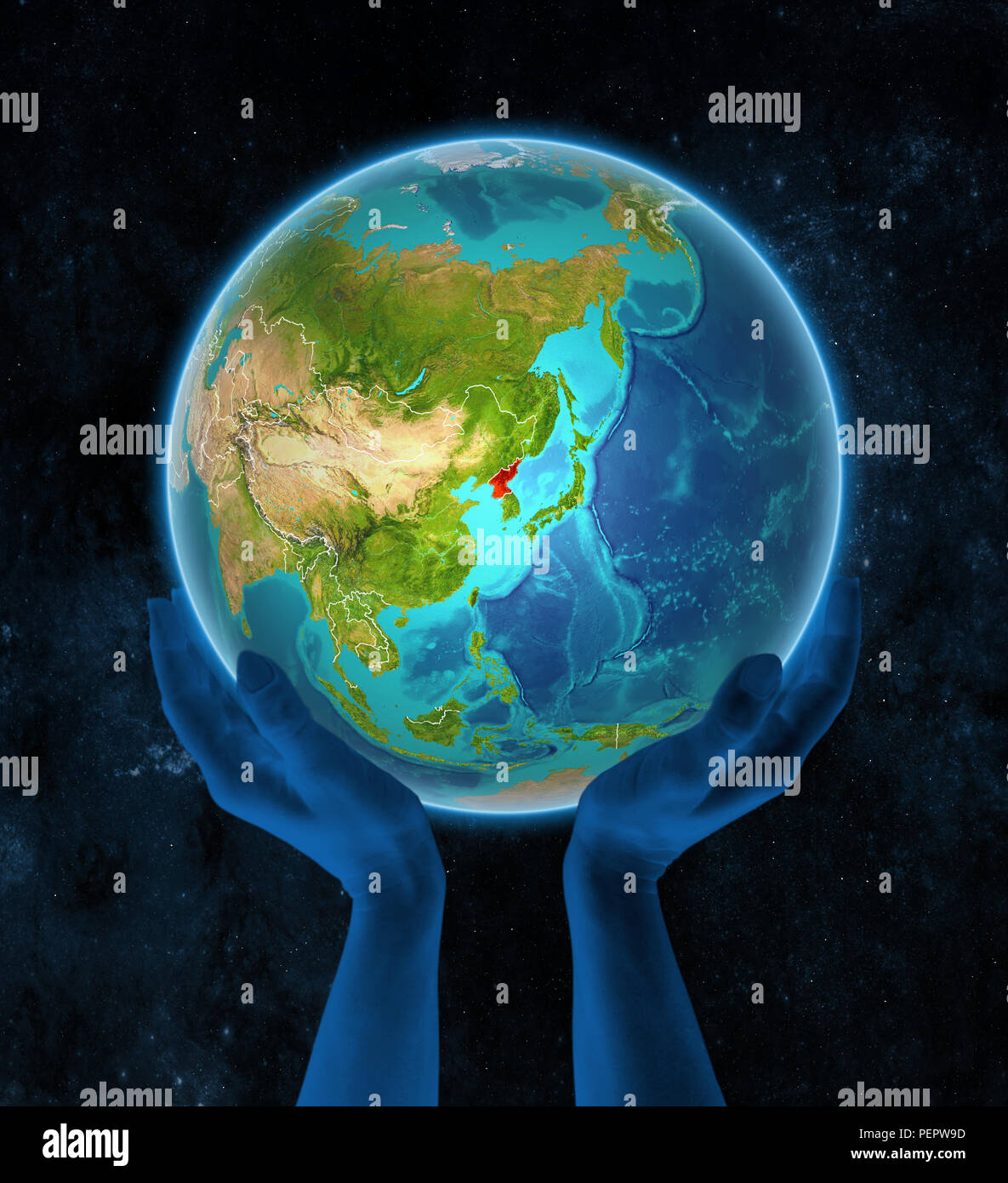 North Korea on planet Earth with visible country borders in hands in ...