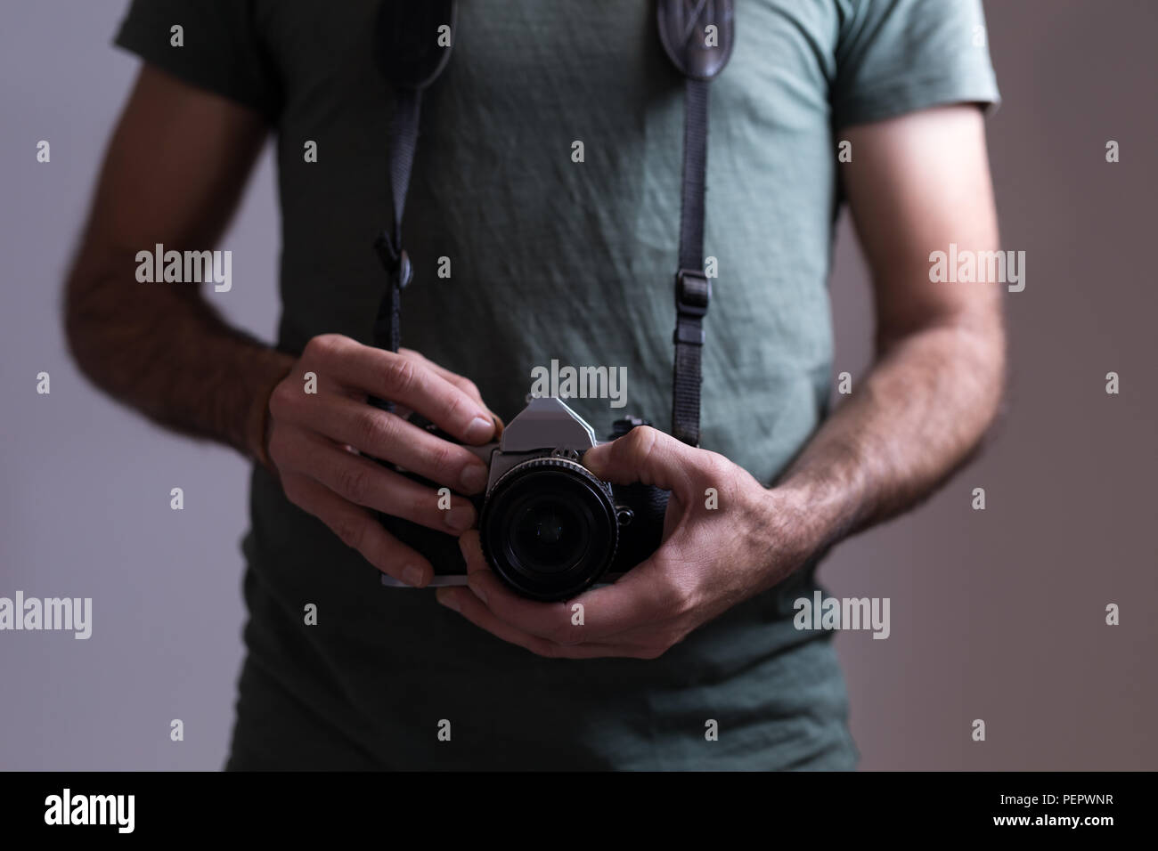 Male photographer standing with digital camera Stock Photo