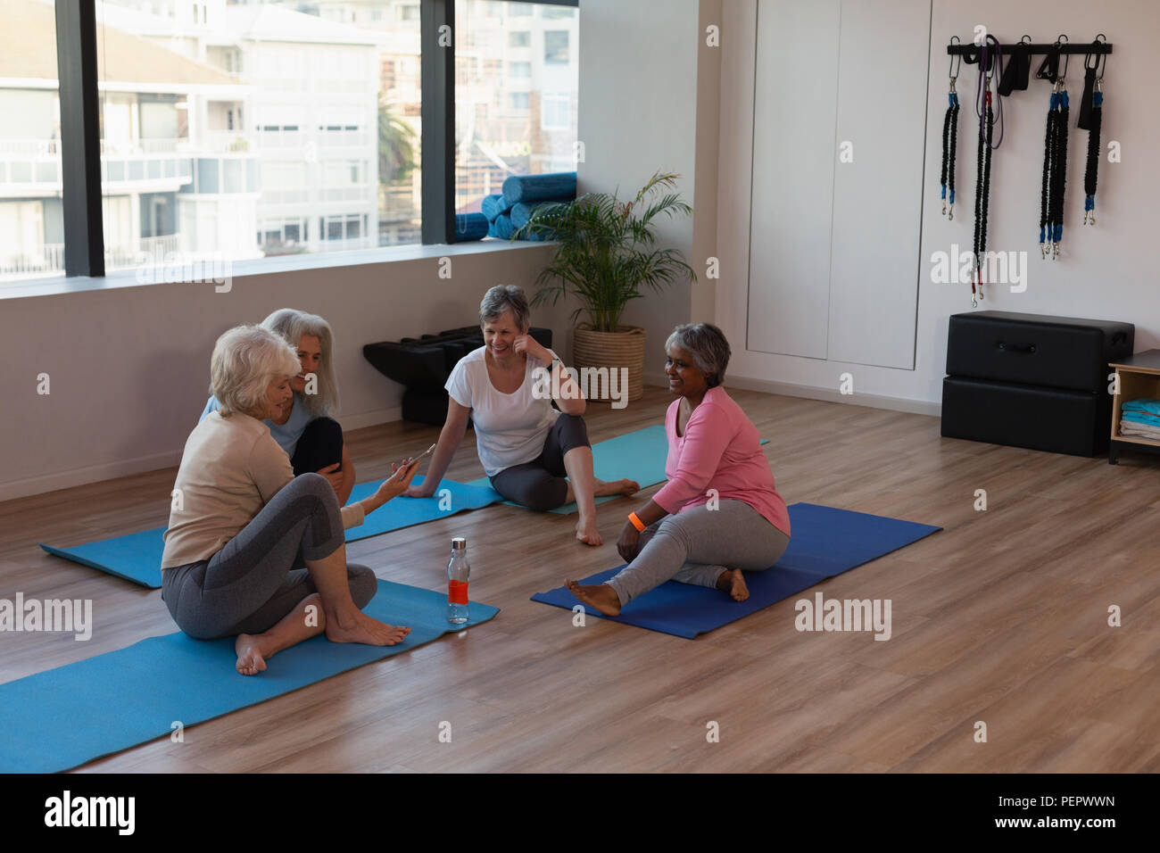 Group of senior women interacting with each other Stock Photo