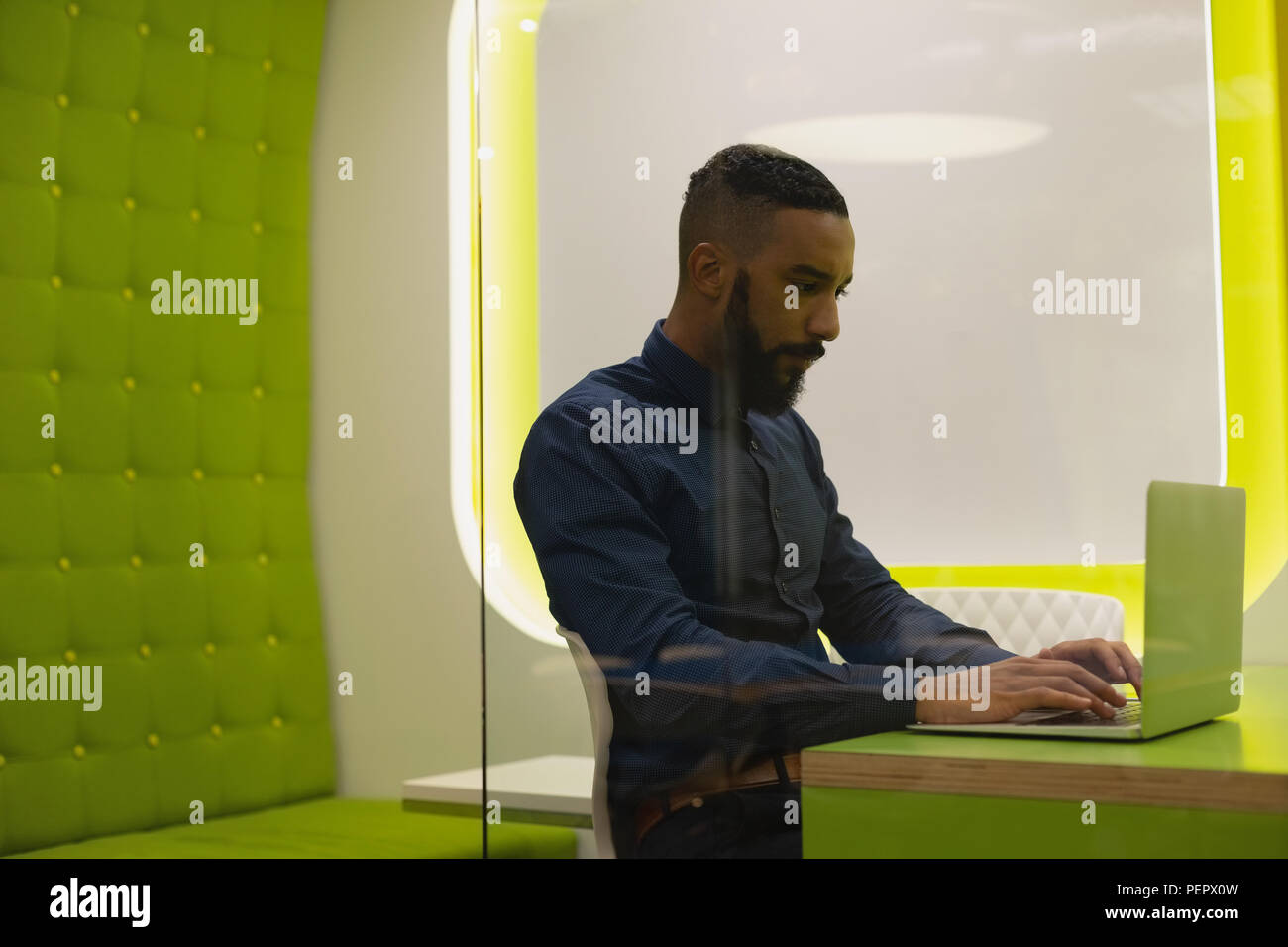 Businessman using laptop in desk Stock Photo