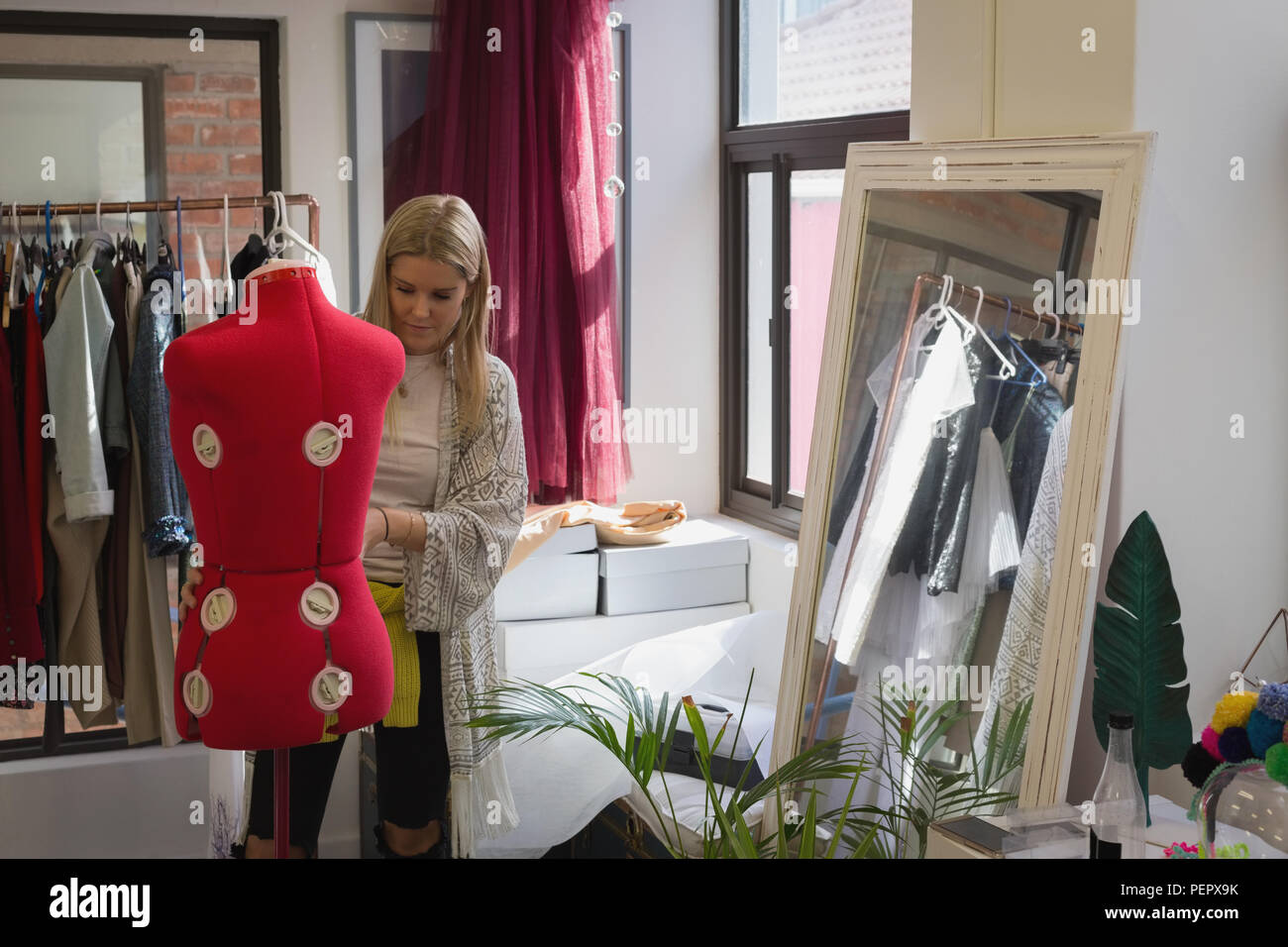 Fashion designer dressing mannequin Stock Photo