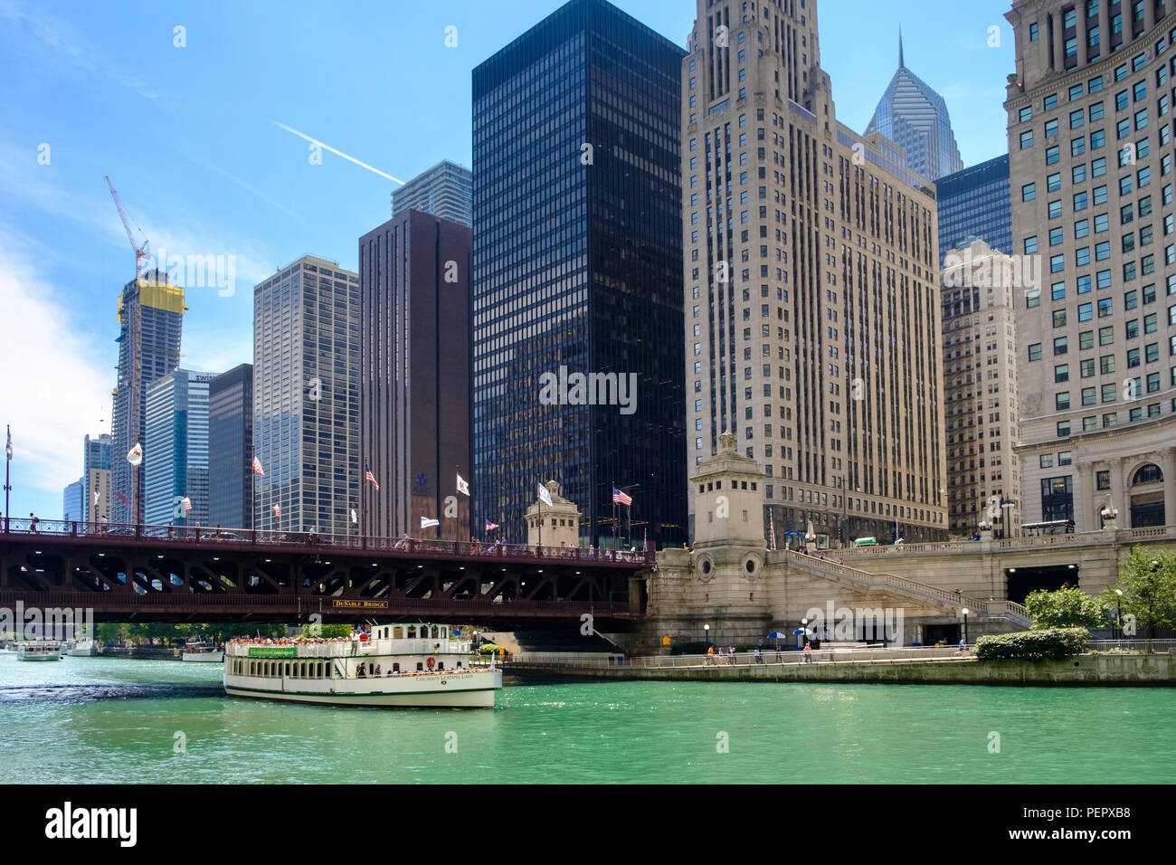 Chicago River and River Cruise with The Riverwalk and surrounding downtown architecture in summer, Chicago, Illinois, USA Stock Photo