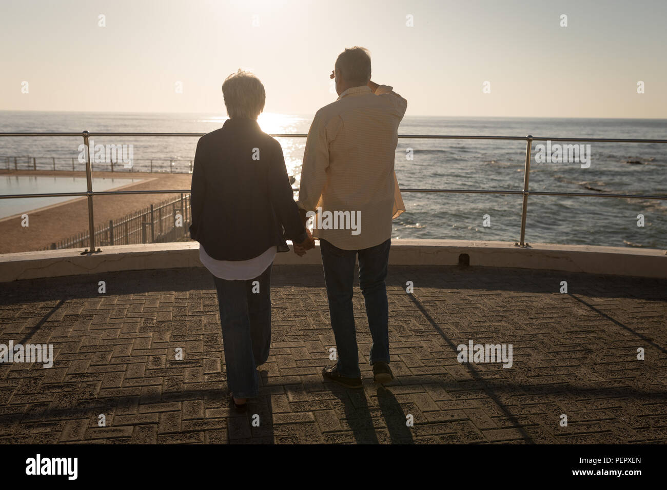 Elderly couple holding hands sky hi-res stock photography and images ...