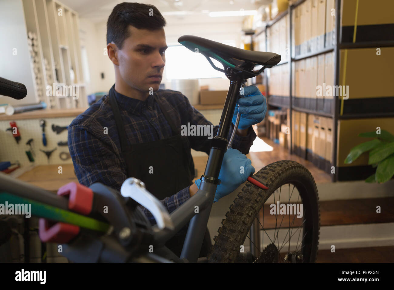 Man adjusting bicycle seat with spanner Stock Photo Alamy