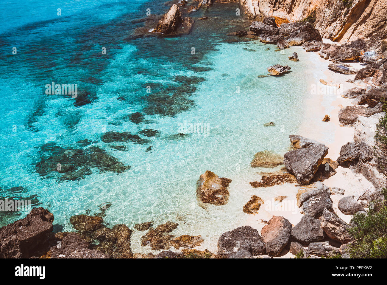 Hidden empty beach with pure clear turquoise sea water near white rock cliffs located in famous beach of Platys and Makrys gialos, Argostoli, Cefalonia island, Ionian, Greece Stock Photo