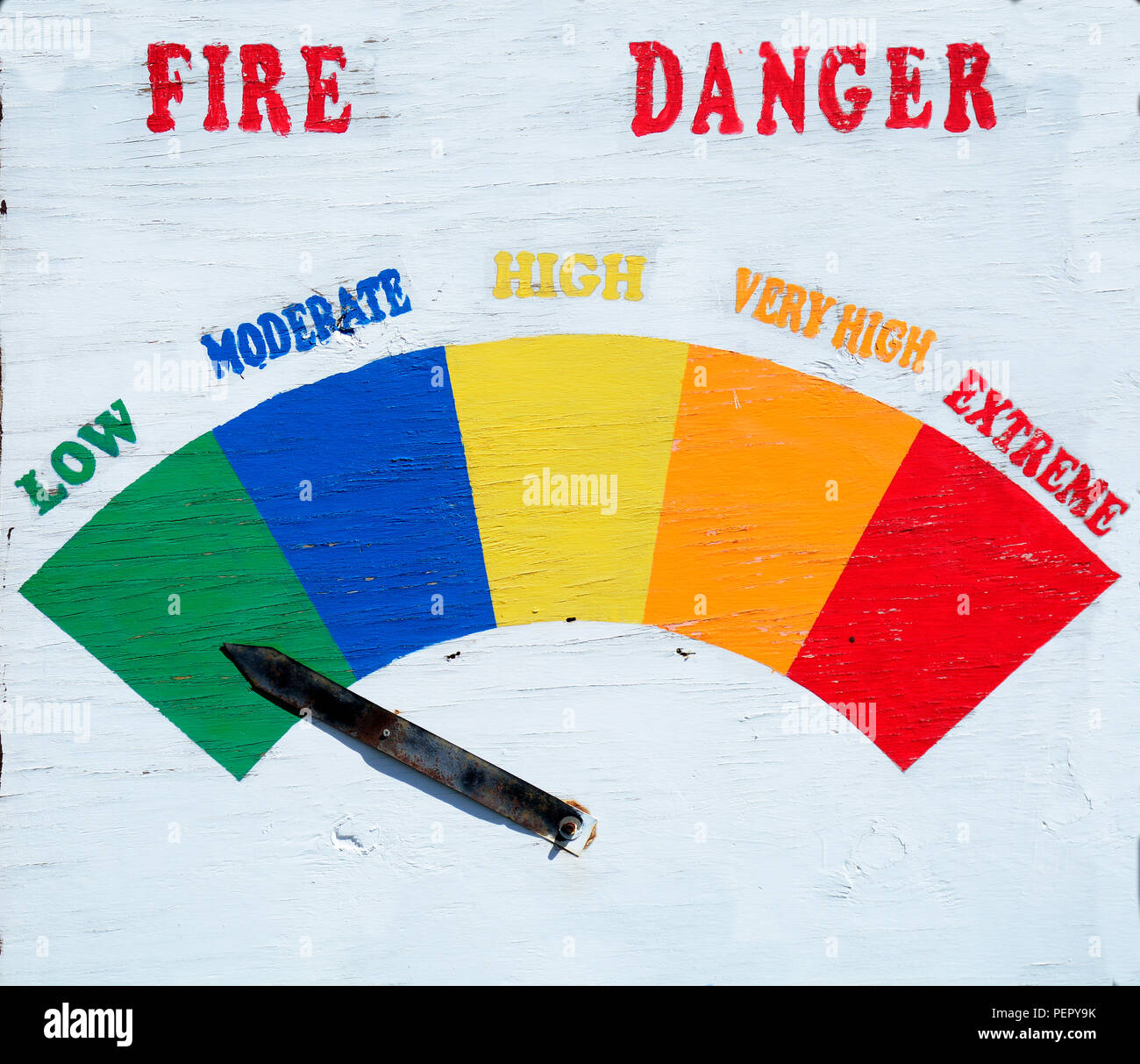A handmade fire danger sign indicates that the fire danger is low. Stock Photo
