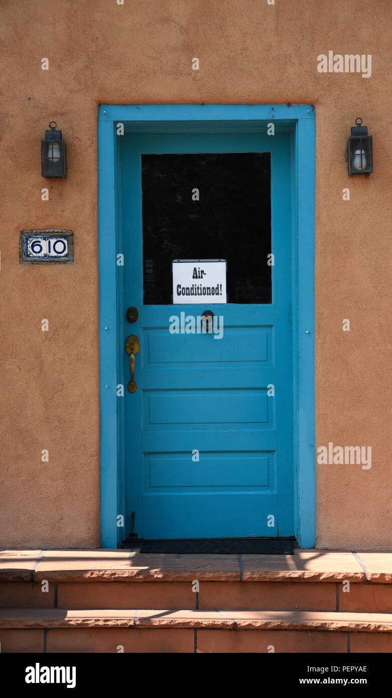 A blue art gallery door with an ‘Air-Conditioned!’ sign. Stock Photo