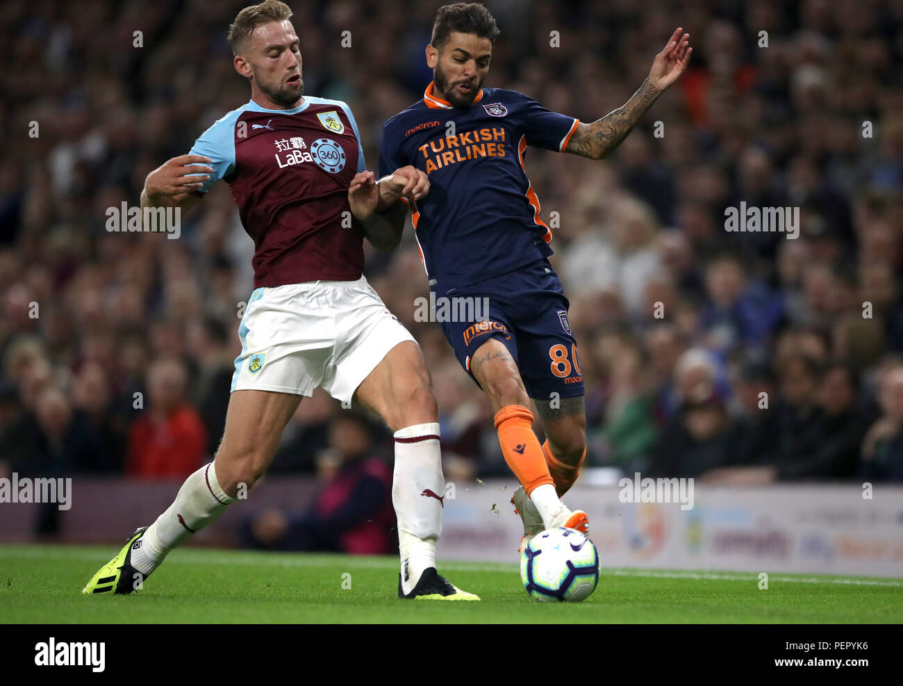 Burnley's Charlie Taylor (left) and Istanbul Basaksehir's Junior Caicara battle for the ball during the UEFA Europa League, Third Qualifying Round match at Turf Moor, Burnley. Stock Photo