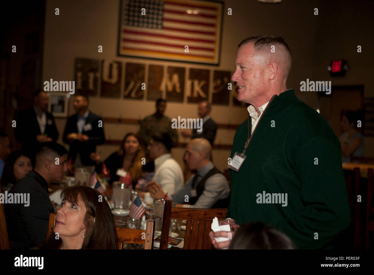 U.S. Marine Corps Brig. Gen. Edward Banta, Camp Pendleton and MCIWEST Commanding General speaks with honored guests prior to the start of the Food Industry Feeding Heroes (FISH) dinner, at Iron Mikes lounge on Camp Pendleton Calif., Jan. 21, 2016. The event is hosted by Camp Pendleton and MCIWEST Commanding General, Brig. Gen. Edward Banta, and Mr. Paul Chapa to honor service members for their accomplishments and sacrifices. (U.S. Marine Corps photo by Cpl. Brian Bekkala/MCIWEST-MCB CamPen Combat Camera/Released) Stock Photo