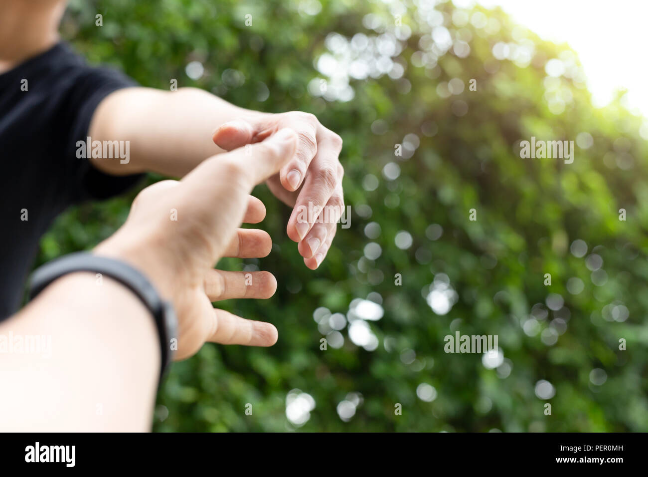 conceptual hand reach out for help with light fare. Stock Photo