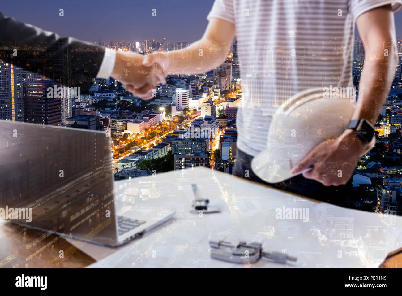 Double exposure of Businessman and Architecture hand shaking hands successful team work. Stock Photo
