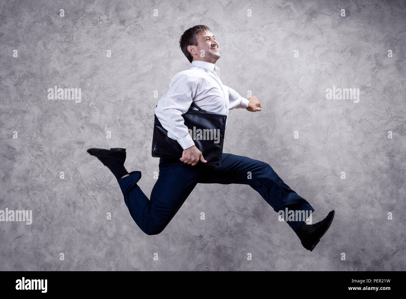 running businessman with briefcase on gray background Stock Photo - Alamy