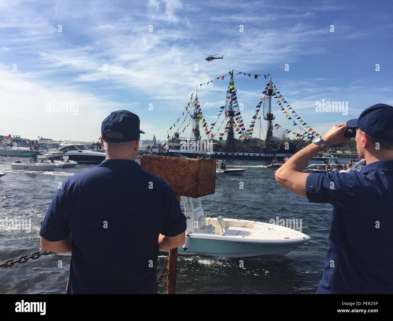 Capt. Gregory Case, commander Sector St. Petersburg, Fla., and Lt. Christopher Rosen, Sector St. Petersburg command center chief, watch over the 2016 Jose Gasparilla Pirate Invasion in the Port of Tampa, Fla., Saturday, Jan. 30, 2016. The Coast Guard partnered with federal, state and local law enforcement agencies to keep the waterways safe during the parade. (U.S. Coast Guard photo by Chief Petty Officer David Schuhlein) Stock Photo