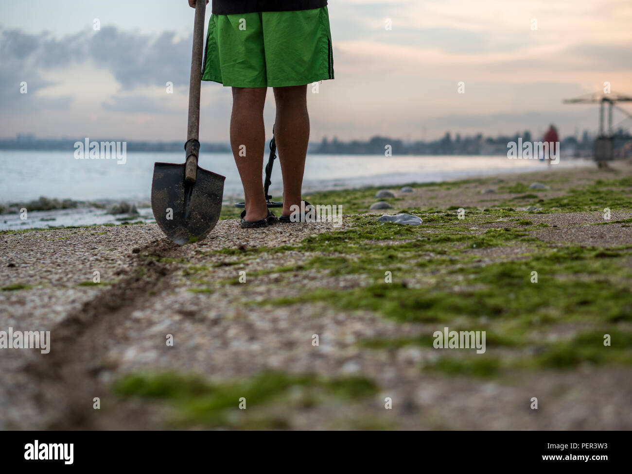 Path of a shovel behind a man searching for a precious metal using a ...