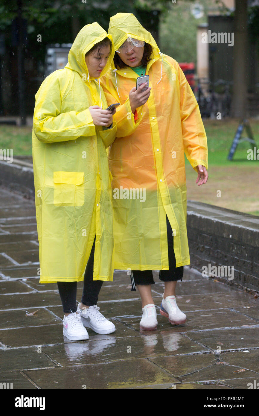 Tourists sightseeing in Cambridge on a wet summers day Stock Photo Alamy