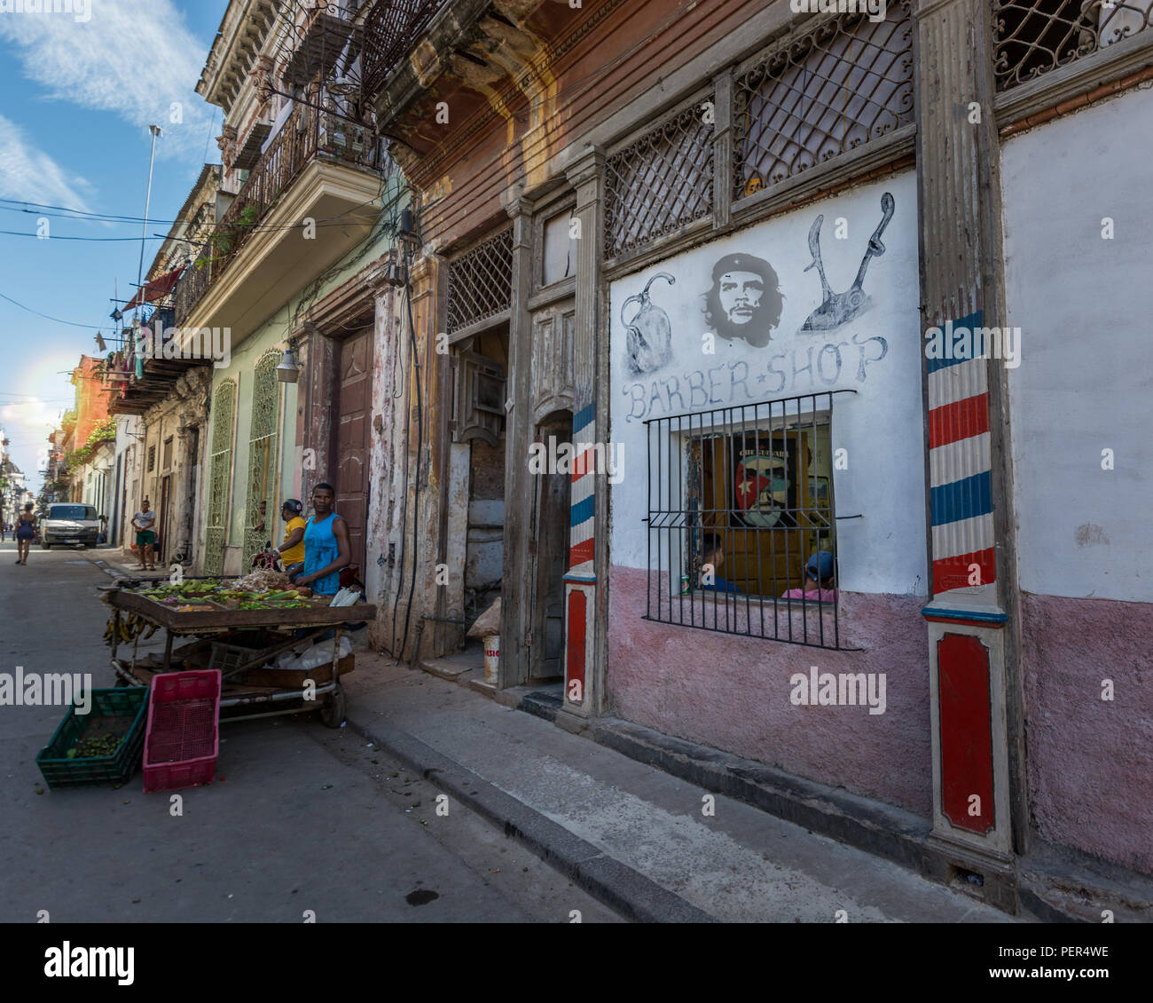 Street photo of Havana, Cuba. Farmer selling fruits in Habana. Image of Che Guevara on the wall, symbol of cuban revolution. Stock Photo