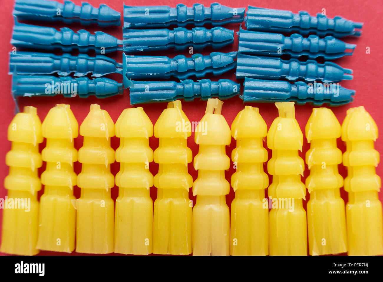 Yellow and blue plastic screw plugs, different sizes Stock Photo