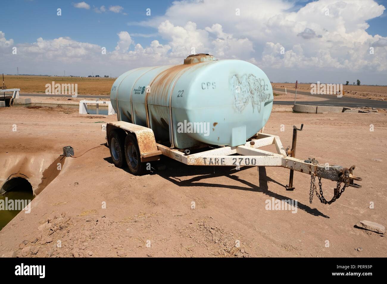 Tank containing chemicals known to cause cancer and birth defects used in farming practices found alongside an irrigation canal in Imperial County. Stock Photo
