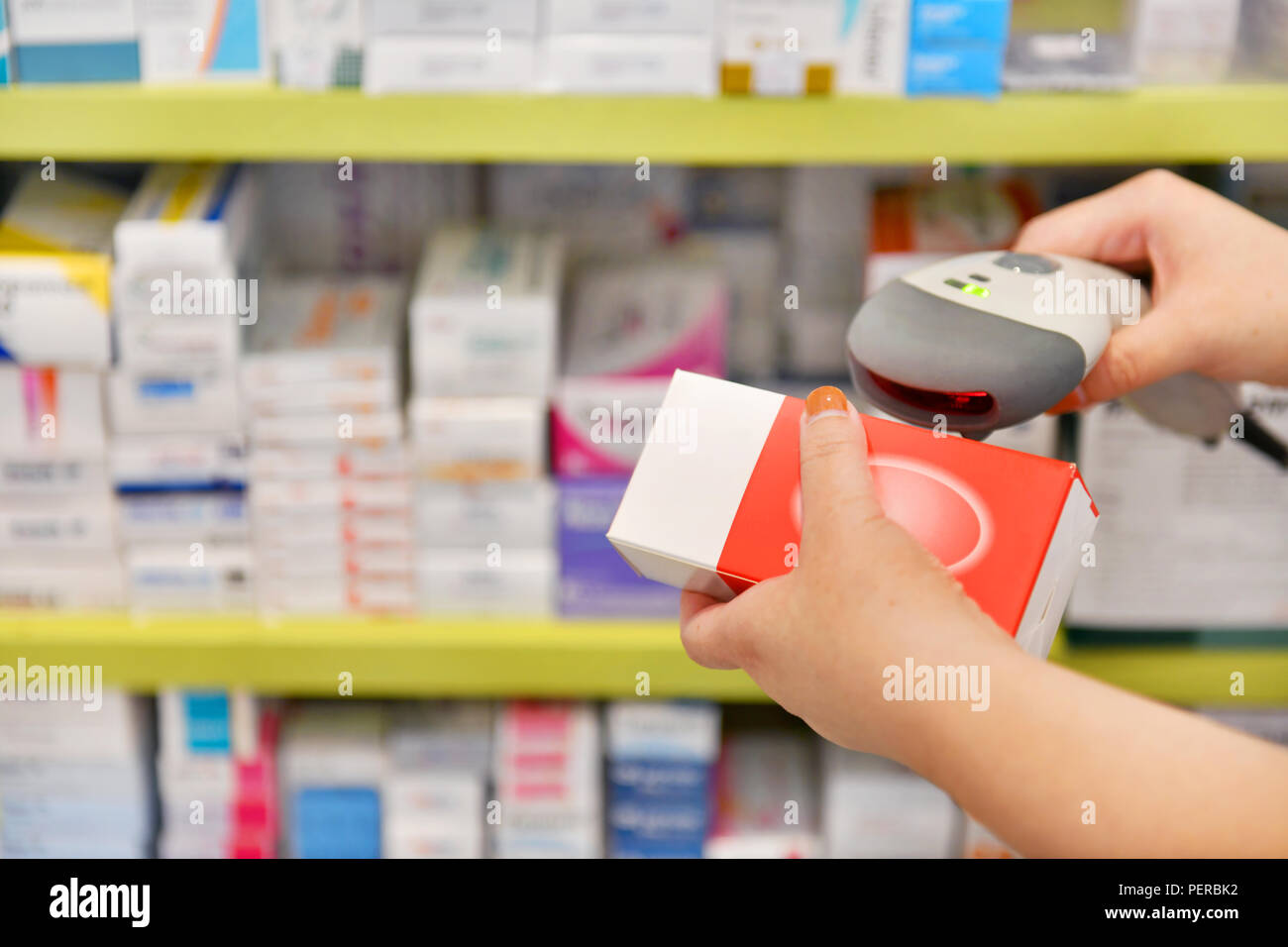 Pharmacist scanning barcode of medicine drug in a pharmacy drugstore. Stock Photo