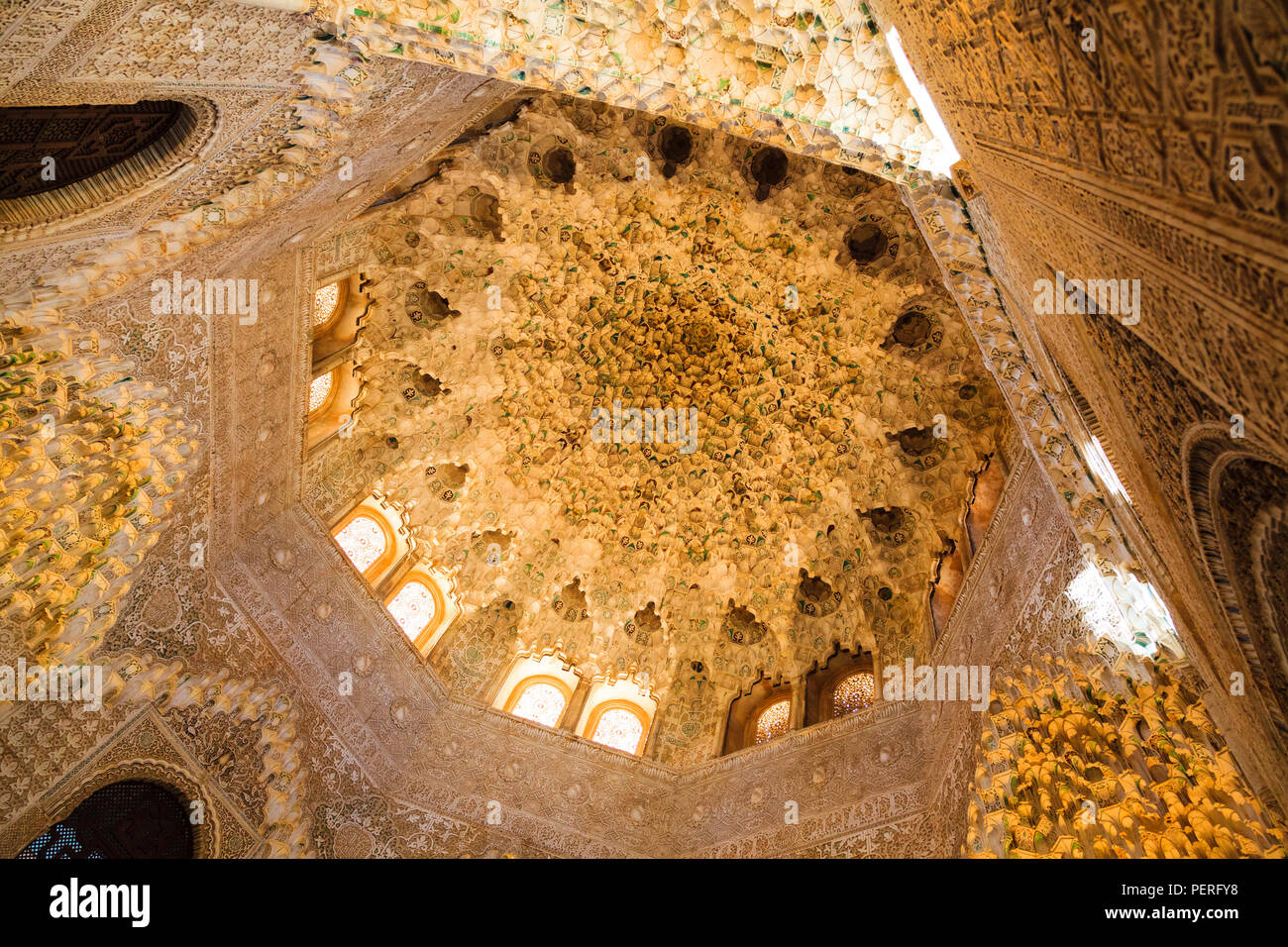 Looking up into ornate and decorative islamic architecture ceiling at the Alhambra Palace in Granada Spain Stock Photo