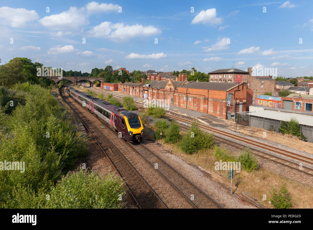 A Crosscountry Trains class 220 voyager train passing the derelict closed railway station at Rotherham Masborough Stock Photo