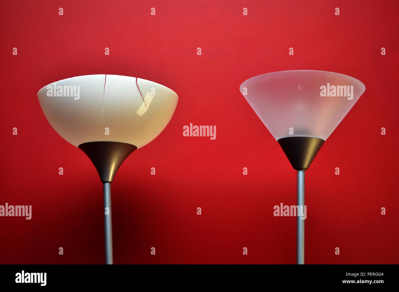 cracked uplighter against a red wall Stock Photo