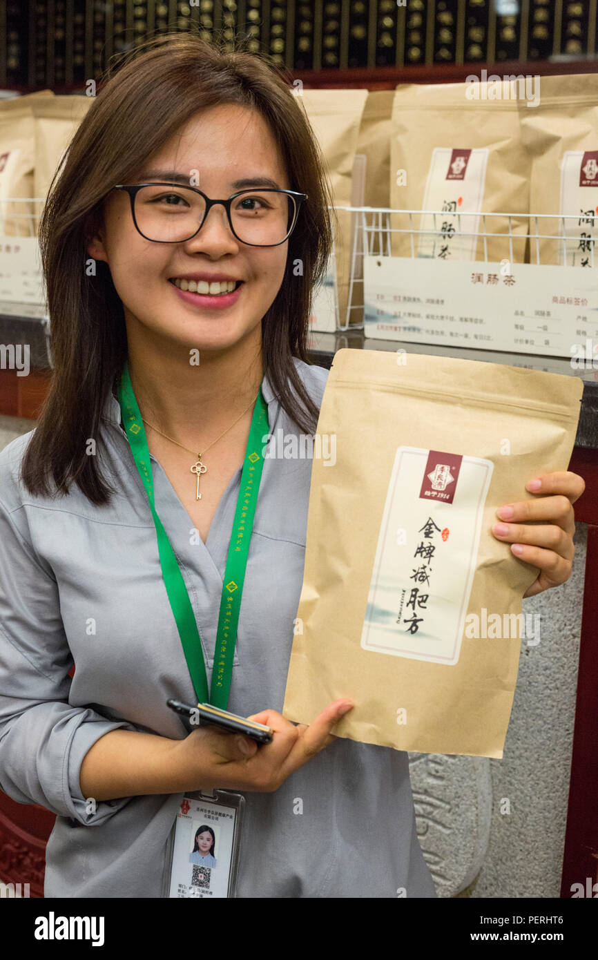 Suzhou, Jiangsu, China.  General Manager of Healthy Industry Company,  Manufacturer of Traditional Chinese Medicine, with Bag of tea for losing weight Stock Photo