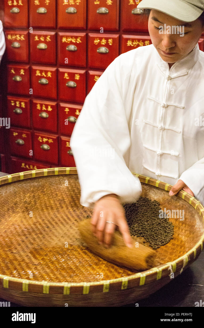 Suzhou, Jiangsu, China.  An Employee Making Pills in a Company Manufacturing Traditional Herbal Medicines. Stock Photo