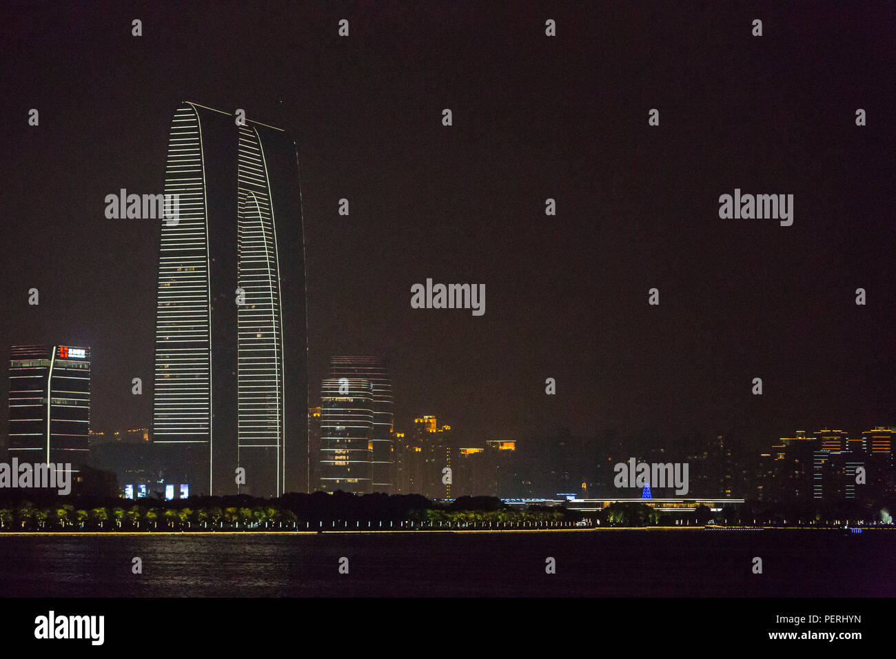 Suzhou, Jiangsu, China.  'Gate of the Orient' Office Building seen from Li Gong Dike at Night. Stock Photo