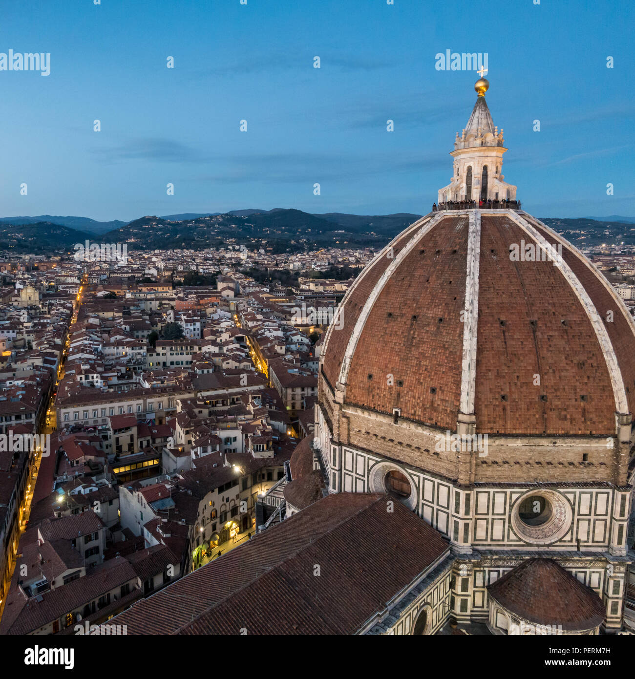 Florence, Italy - March 23, 2018: Tourists gather on the cupola of Florence's Duomo cathedral to watch the sunset. Stock Photo