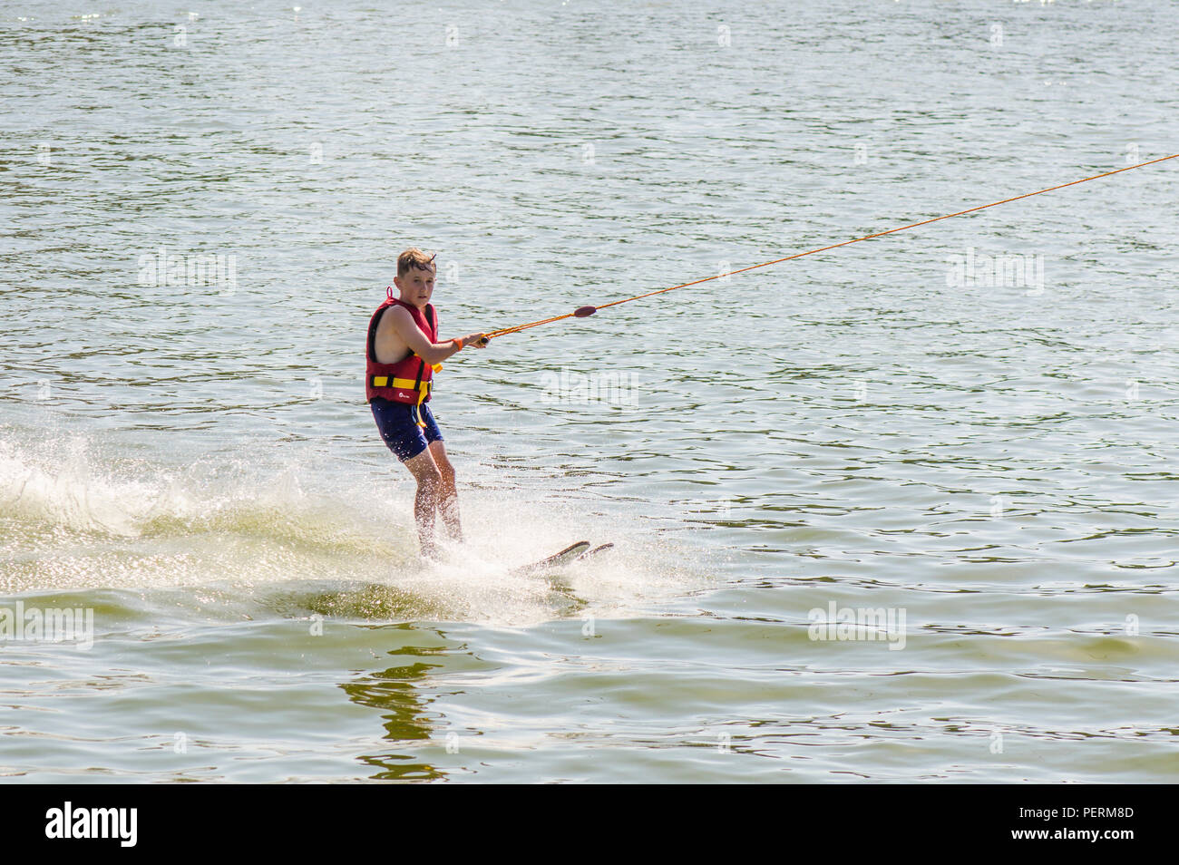 Teenage boy wakeboarding, skurfing, water skiing, on a lake, Wake Park, Pedro de Alcántara, Andalusia, Spain. Stock Photo