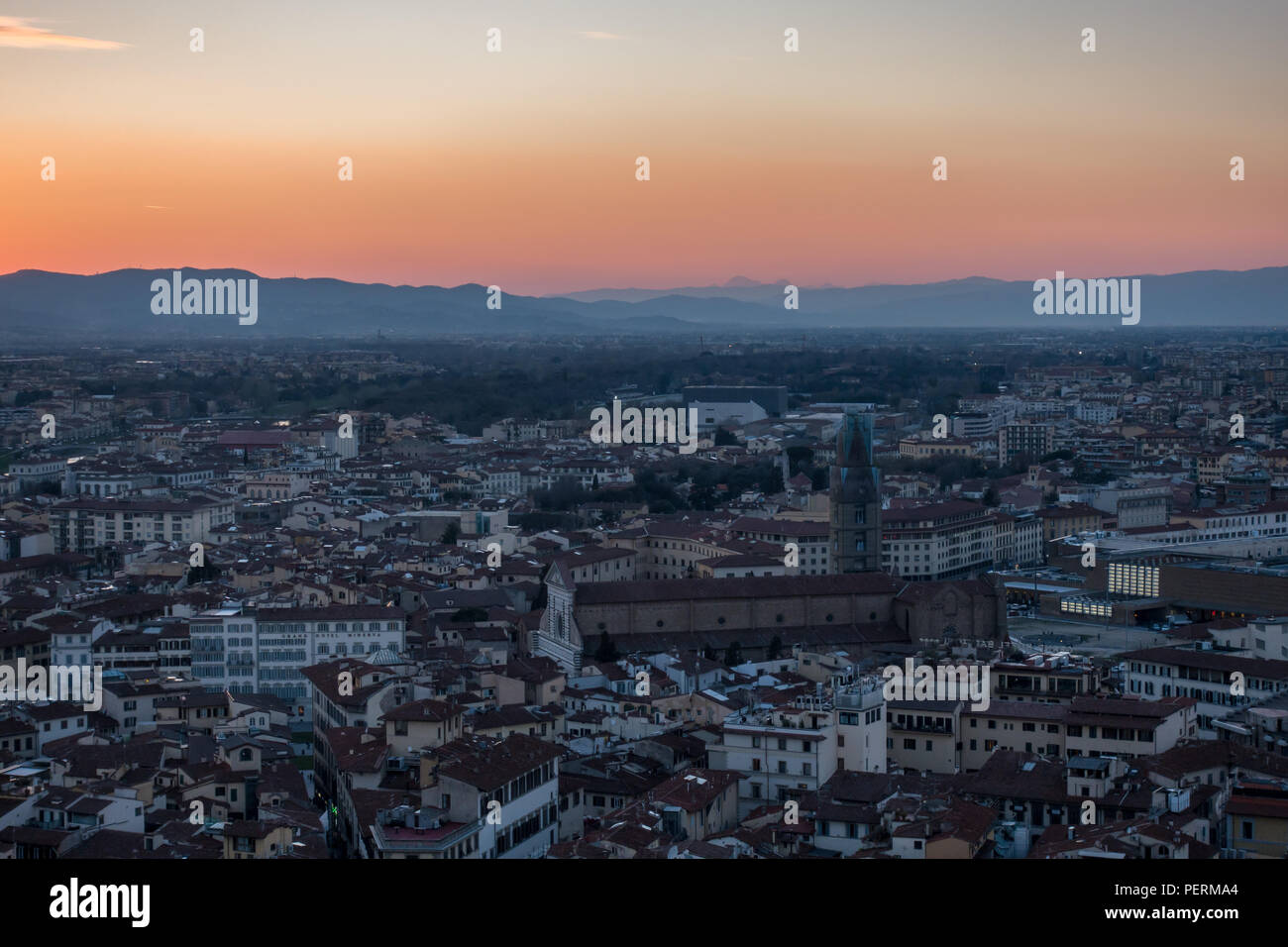 Florence, Italy - March 23, 2018: The sun sets over the hills of Tuscany and the cityscape of Florence, viewed from above. Stock Photo